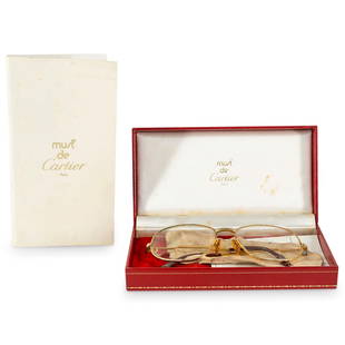 Cartier Bifocal Glasses In Box And Sleeve: DESCRIPTION: Vintage Cartier bifocal glasses featuring a gilt frame. Includes leather sleeve, box, and documentation. CIRCA: 20th Century ORIGIN: France DIMENSIONS: (Glasses) H: 2" W: 0.75" L: 5.5" (B