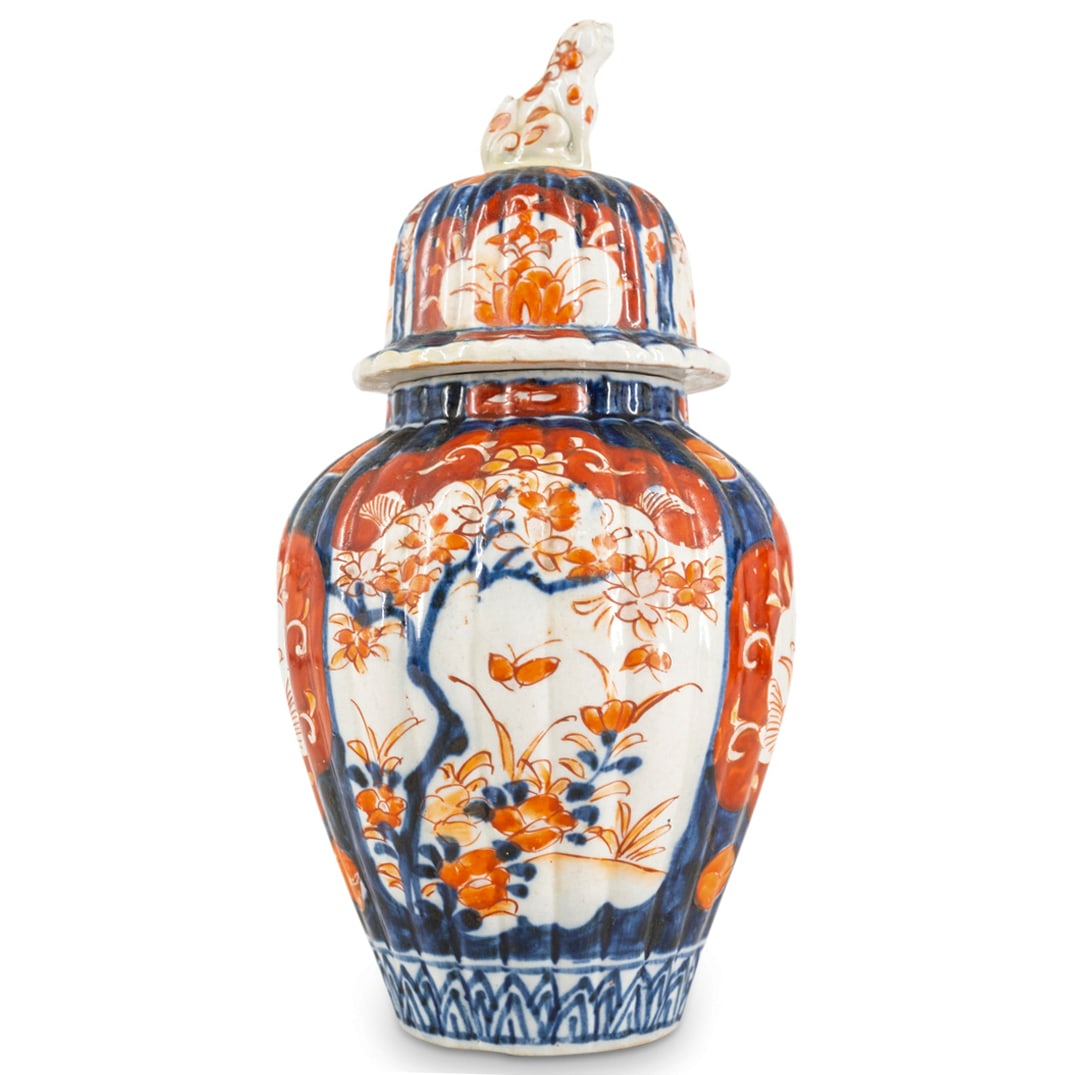 Antique Japanese Imari Porcelain Urn: DESCRIPTION: Antique Japanese Imari porcelain urn featuring ribbed form and floral and foliage motifs. Completed with with komainu ("foo dog") finial. CIRCA: Late 19th - Early 20th Century ORIGIN: Jap