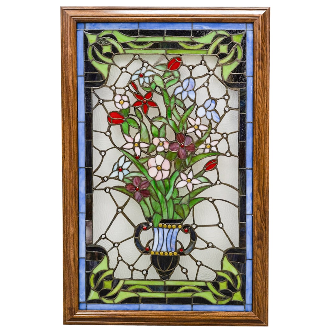 Leaded Stained Glass Window In Wooden Frame: DESCRIPTION: Leaded stained glass window in wooden frame depicting an elaborate footed amphora vase with floral bouquet. CIRCA: 20th Century DIMENSIONS: H: 37" W: 23" CONDITION: Good condition. Ready
