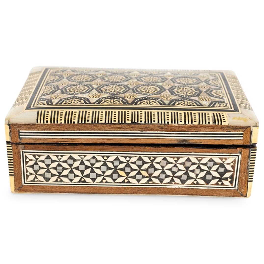 MOP & Bone Parquetry Jewelry Box: DESCRIPTION: Syrian hinged wooden jewelry box featuring parquetry, velvet-lined interior and mother of pearl and bone insets. CIRCA: Mid 20th Century ORIGIN: Syrian or Moroccan DIMENSIONS: H: 2.5" W: 