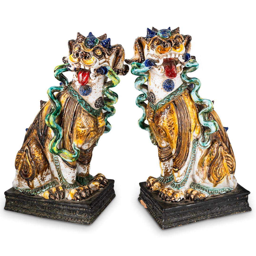 Pair Of Large Antique Chinese Sancai Guardian Lions: DESCRIPTION: Two mirrored ceramic guardian lions, each featuring an open devil's mouth, a coat of lead glaze in four colors, spikes along its back and around the king medallion on its forehead. Each p