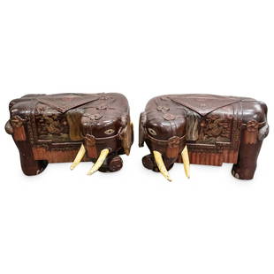 Pair Of Chinese Elephant Form Wooden Benches: DESCRIPTION: Two matching lacquered benches, each carved from wood in the form of an elephant donning a saddle decorated with clouds, bats, dragons pursuing a flaming pearl, and a Shou crest. Each is