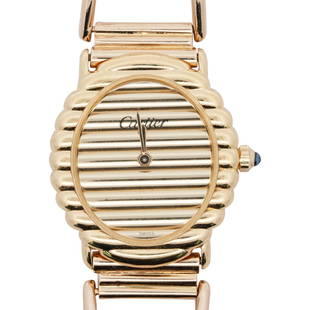 Vintage Cartier Gold Fluted 18k Gold Watch: DESCRIPTION: A vintage Cartier watch features an 18k yellow gold casing, Mechanical movement with fluted bezel and dial, marked "Cartier" and finished with a crystal sapphire cabochon at the crown. Th