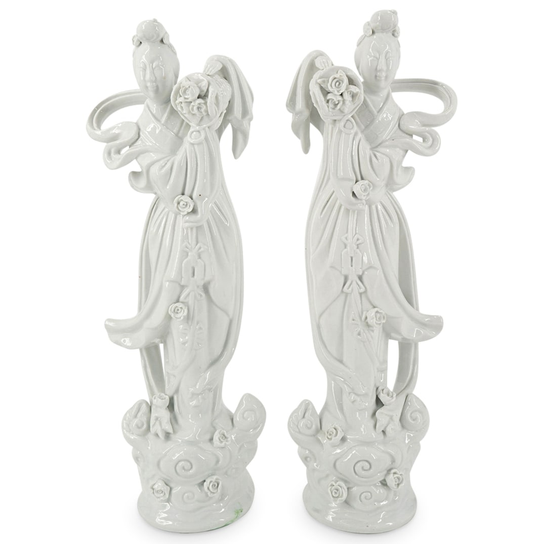 Pair Of Chinese Mirrored Blanc De Chine Goddesses: DESCRIPTION: Two mirrored blanc-de-Chine porcelain sculptures, each depicting a tennyo ("heavenly woman") robed and bearing a basket of flowers while standing top clouds. CIRCA: 20th Century ORIGIN: C