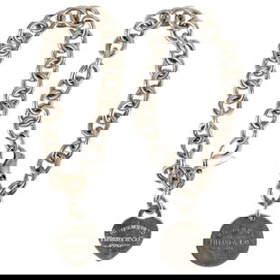 (2 Pc) Tiffany & Co Sterling Silver Bracelets: DESCRIPTION: Two Tiffany & Co. sterling silver bracelets, one featuring circular pendant and the other featuring heart-shaped pendant. Each marked with "925" on pendant and chain clasp. Total weight: