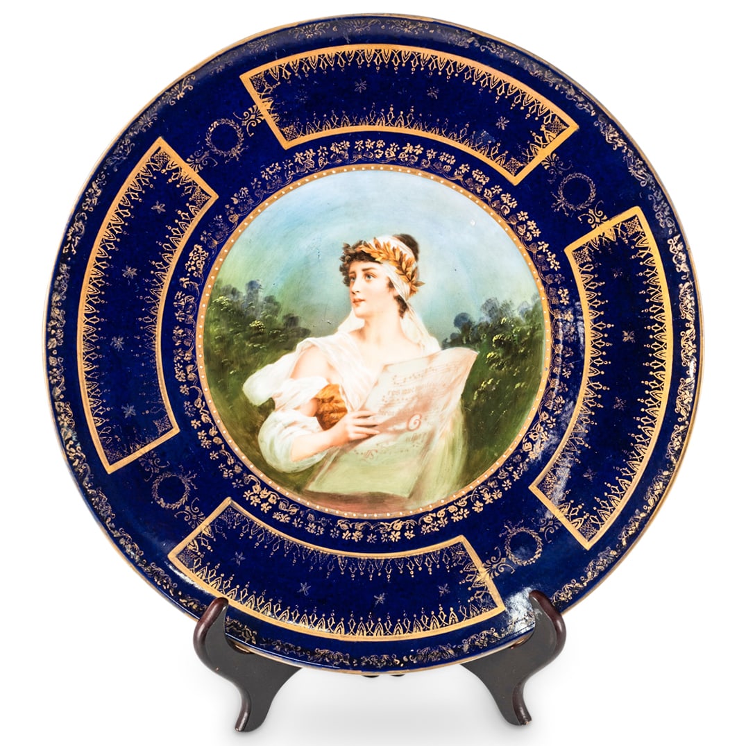 Antique Royal Vienna Style Porcelain Charger: DESCRIPTION: Antique Royal Vienna-style porcelain charger featuring cobalt blue ground and central transferred scene of a woman wearing a laurel wreath and holding sheet music. Completed with gilt flo