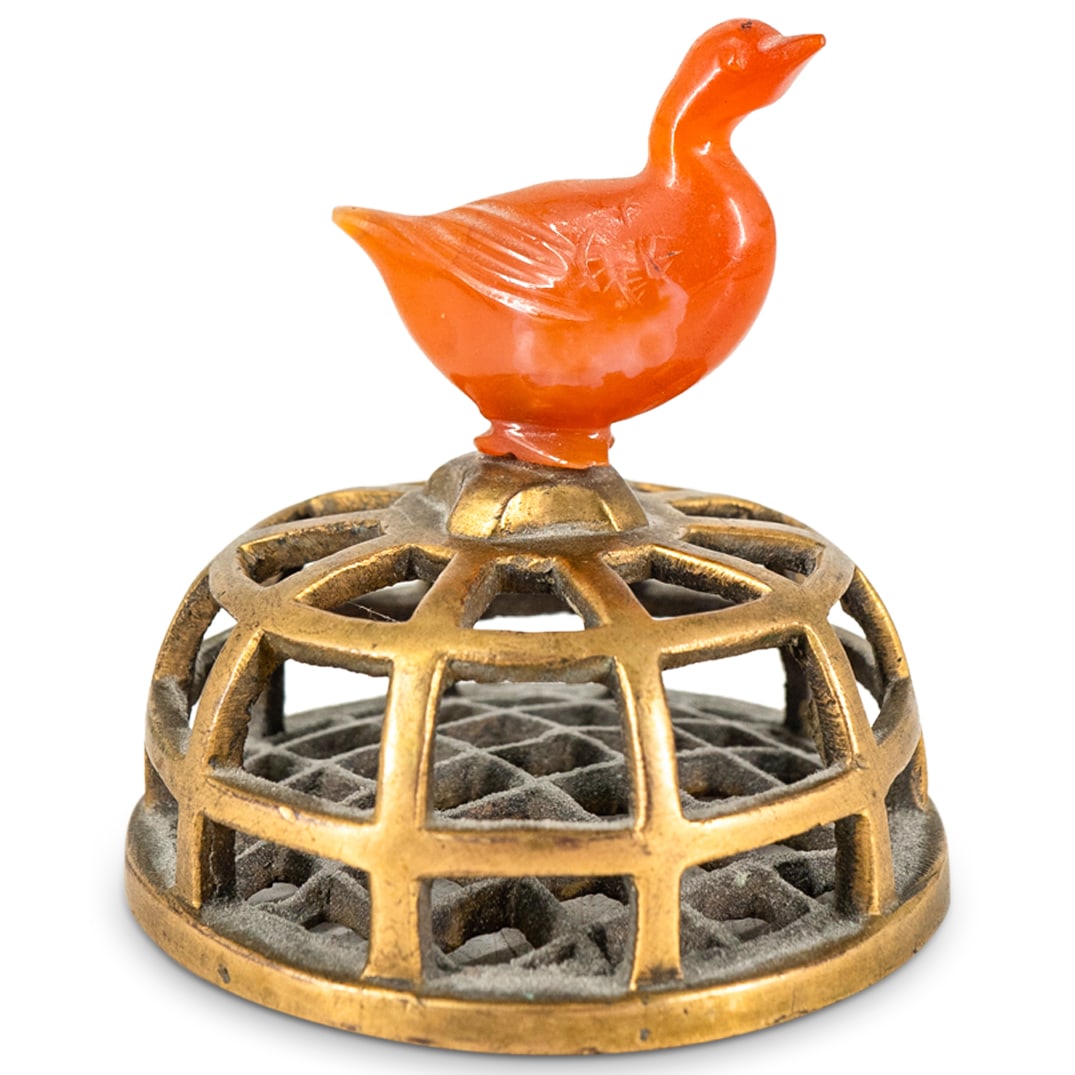 Antique Chinese Carnelian Duck Reticulated Paperweight: DESCRIPTION: Antique Chinese reticulated gilt mixed metal paperweight featuring carved carnelian duck at top. CIRCA: 20th Century ORIGIN: Chinese DIMENSIONS: H: 3" Diameter: 3" - CONDITION: Minor gilt