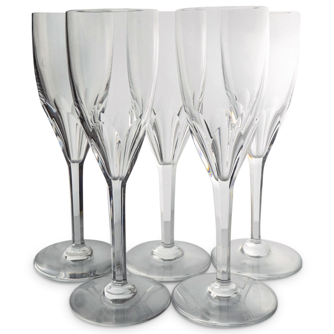 (5 Pc) Baccarat Crystal "Genova" Champagne Flutes: DESCRIPTION: (5 Pc) Baccarat crystal champagne flutes in the Genova pattern, decorated with a thumbprint cut bowl and six sided stem. Marked with Baccarat stamp hallmark on the underside. This set inc