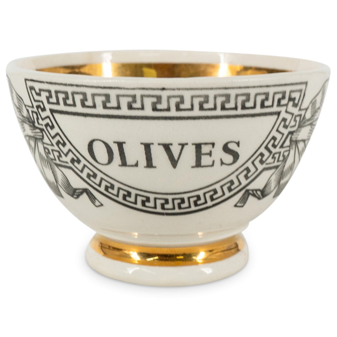 Fornasetti Porcelain Olive Cup: DESCRIPTION: Fornasetti porcelain olive cup with round footed design. Marked at underside: "Fornasetti, Made In Italy, Fornasetti, Milano" CIRCA: 20th Century ORIGIN: Italy DIMENSIONS: H: 2" x D: 3" -