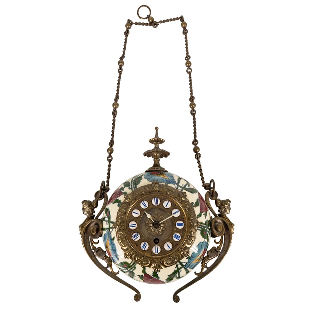 19th Cent. Zsolnay Wall Clock: DESCRIPTION: Antique Zsolnay polychrome porcelain hanging wall clock featuring brass hardware, two nude busts, floral finial, Roman numerals and hand painted floral and foliage motifs. Completed with