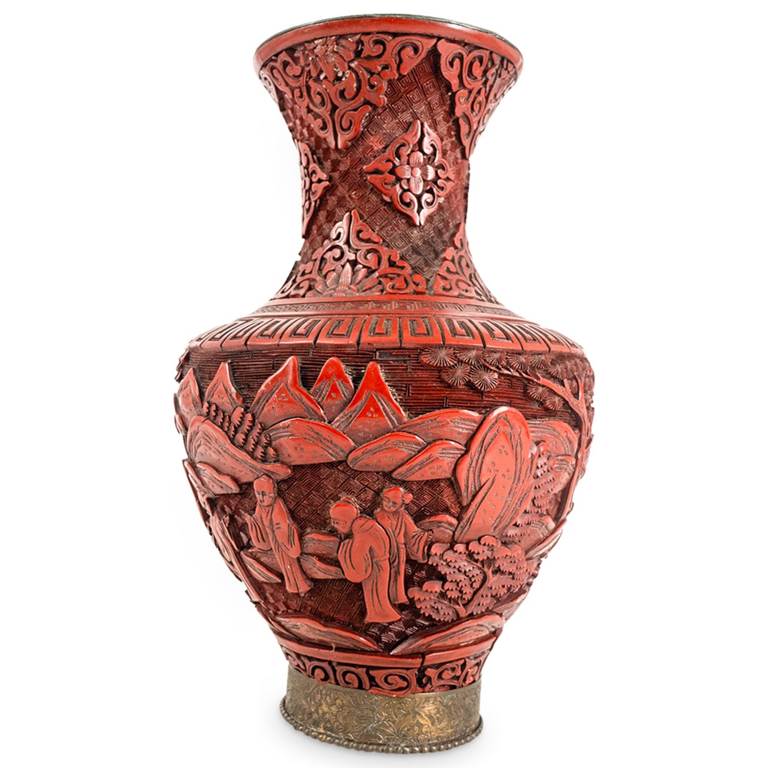 Chinese Cinnabar Vase: DESCRIPTION: Chinese cinnabar vase featuring relief figural, floral and foliage motifs and gilt mixed metal mount decorated with further floral and foliage motifs. CIRCA: 20th Century ORIGIN: China DI