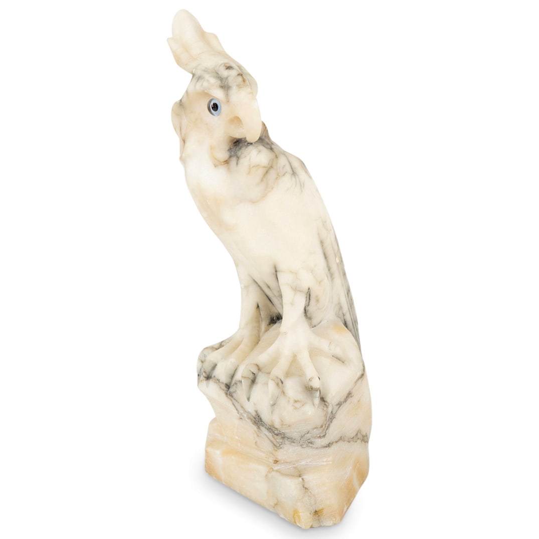 Alabaster Cockatoo Sculpture: DESCRIPTION: Alabaster sculpture depicting a cockatoo bird. CIRCA: Late 20th - Early 21st Century ORIGIN: European DIMENSIONS: H: 12.5" W: 4.5" L: 5.75" CONDITION: Repair to crest. Minor repair to bas