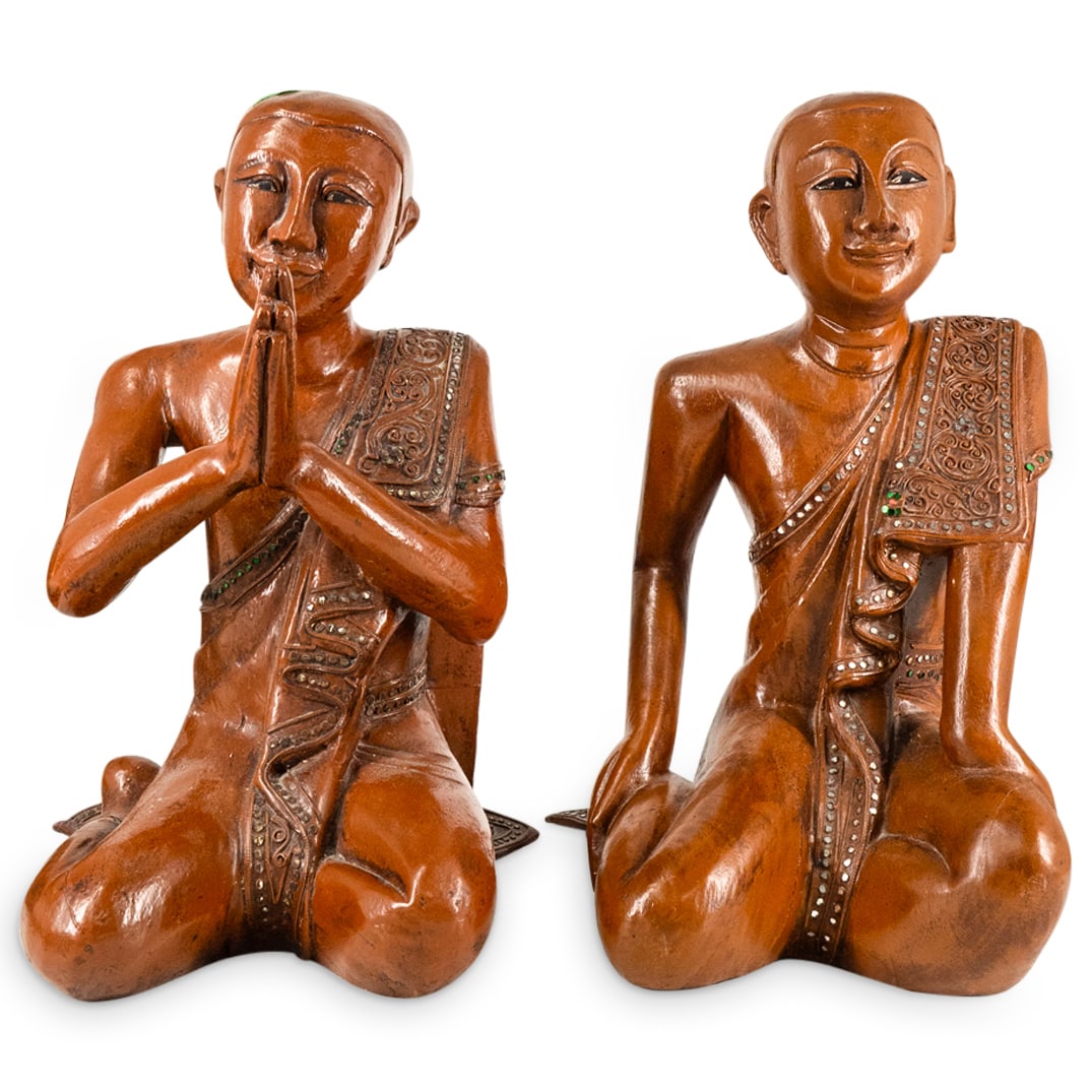 Pair Of Siamese Carved Wood Arhats: DESCRIPTION: Two matching carved wood sculptures, each depicting an arhat wearing a sash dotted with mirrors and seated in the bodhisattva posture: one with hands together, one with hands on legs. Eac