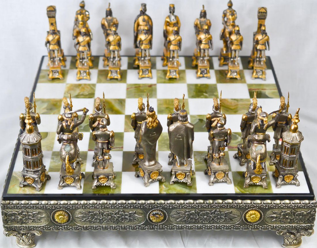 Vintage silver & gold over bronze chess set: DESCRIPTION: Vintage silver & gold over bronze chess set on a onyx gilded bronze base. Signed CIRCA: 1930-1950s MADE IN: Italy DIMENSIONS: Board is 16" by 16" and each piece is approx 5" high