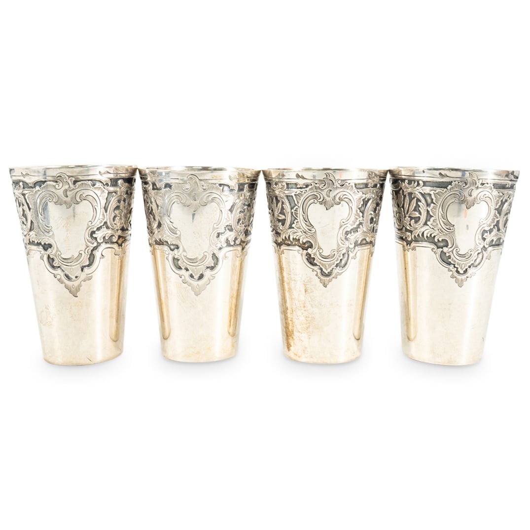 (4 Pc) Bruckmann & Sohne 800 Silver Cups: DESCRIPTION: Four cups crafted from 800 silver by Bruckmann & Sohne, each featuring floral, foliage, and medallion designs around the lip. Total weight of all pieces together: 296 g. CIRCA: 19th to ea
