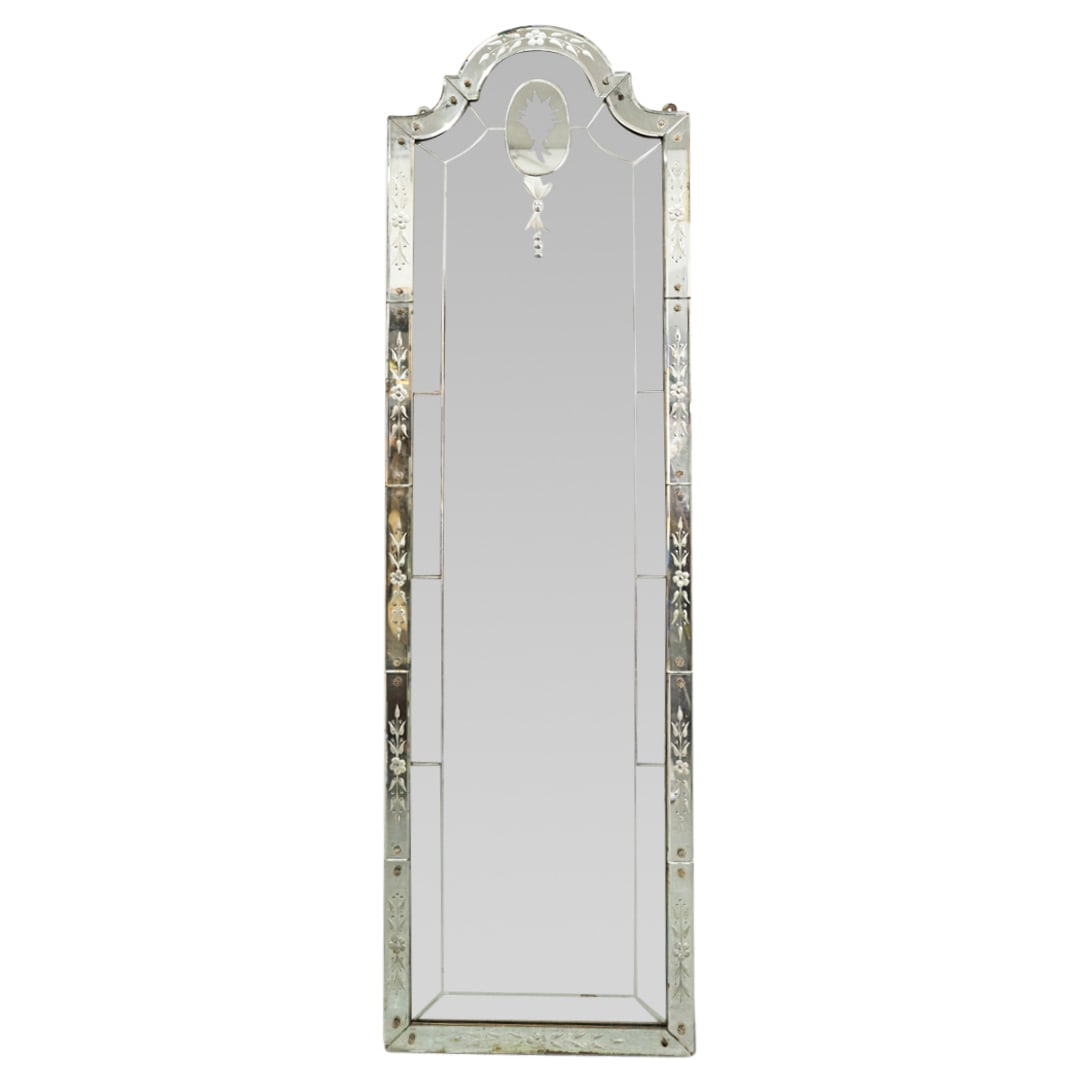 Venetian Glass Mirror: DESCRIPTION: Venetian glass mirror featuring floral and foliage motif and beveling. CIRCA: Mid - Late 20th Century ORIGIN: Italian DIMENSIONS: H: 65.25" W: 18" CONDITION: Minor desilvering in spots. L