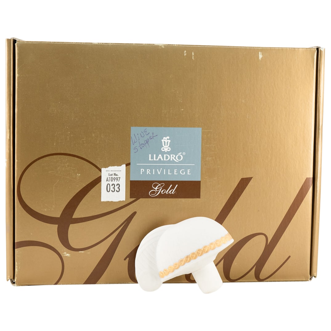 Lladro Porcelain Centurion Hall Bottle Wine Stopper: DESCRIPTION: Lladro Porcelain Centurion Hall Bottle Stopper. 2010 Gold Dealer Piece. With Lladro stamp and original Lladro Privilege Gold box. CIRCA: 20th Century ORIGIN: Spain DIMENSIONS: H: 2 1/2" W