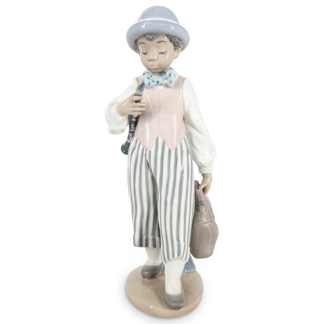 Lladro "Jazz Clarinet" Glazed Porcelain Figurine: DESCRIPTION: Lladro porcelain figurine titled "Jazz Clarinet" designed by sculptor Antonio Ramos. The piece has a glazed finish. Model number: #5928. Year Issued: 1992. Year Retired: 2017. Stamped on 