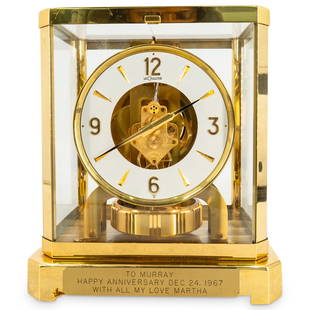 Vintage Jaeger LeCoultre Gilt Bronze Atmos Clock: DESCRIPTION: Atmos clock by LeCoultre featuring a gilt bronze and glass panel housing for an otherwise exposed movement. Piece was given as an anniversary gift as evidenced by the inscription on a