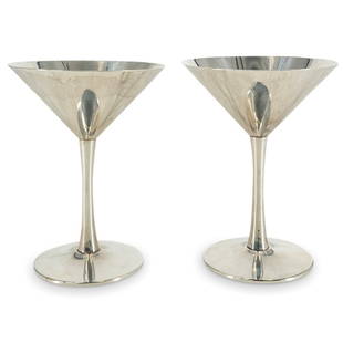 Pair of Cartier Sterling Cocktail Cups: DESCRIPTION: A pair of vintage Cartier sterling silver cocktail cups with modernist forms. Stamped: "Cartier Sterling, 15" CIRCA: 20th Cent. ORIGIN: France DIMENSIONS: H: 5.5" x D: 4.25" (Total Weight