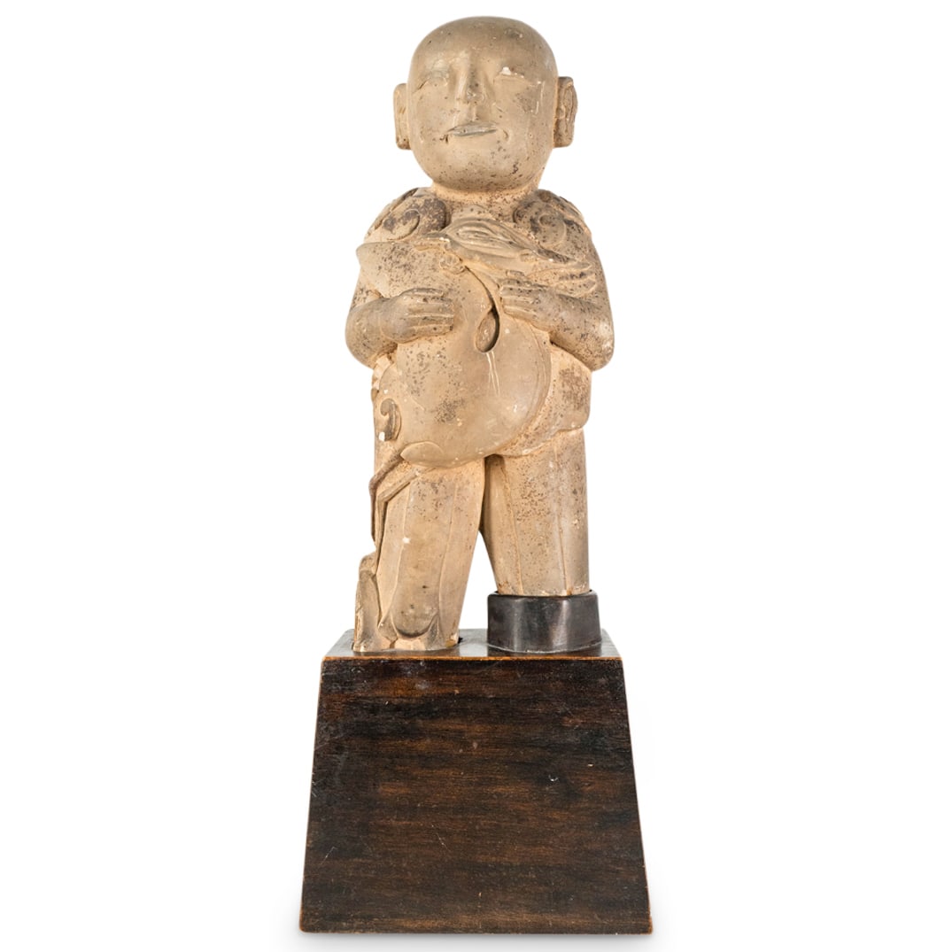 Chinese Archaic Stone Carved Figure with Phoenix: DESCRIPTION: A Chinese Archaic stone carved statue depicting an upright figure with phoenix clutched against his chest and scrolling smoke cloud accents. Statue mount to wood display base. CIRCA: Arch