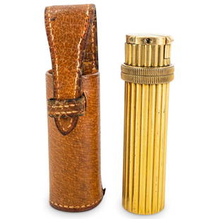 Antique Hermes Gilt Brass Lighter W/ Leather Case: DESCRIPTION: Antique Hermes gilt brass lighter featuring a revolving top and a ribbed design. Includes leather case emblazoned "HERMES" in gilt lettering. CIRCA: MId-20th Century ORIGIN: France DIMENS