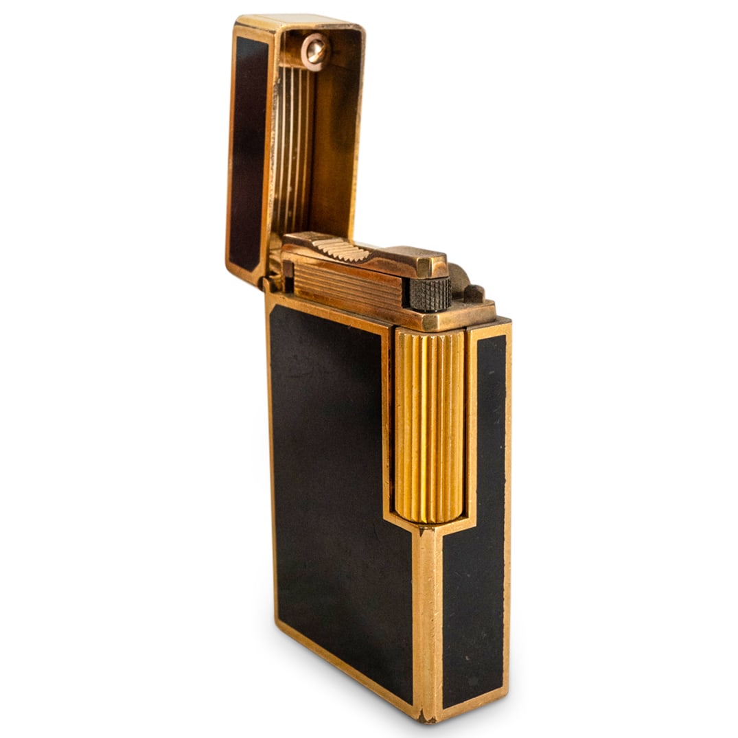 S.T. Dupont Gold Plated Laque De Chine Lighter: DESCRIPTION: S.T. Dupont lighter composed of an overall ridged gold-plated foundation, finished with a black laque de chine center. Marked along the underside "Dupont Made In France". With chinese cal