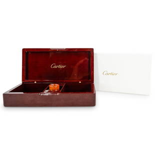 Cartier Wooden Jewelry Box: DESCRIPTION: A Cartier gloss wood Jewelry box opens by gold tone hinges to reveal interior compartments. Bares "Cartier" with gold tones, additionally accompanied by a wooden loop and original box.