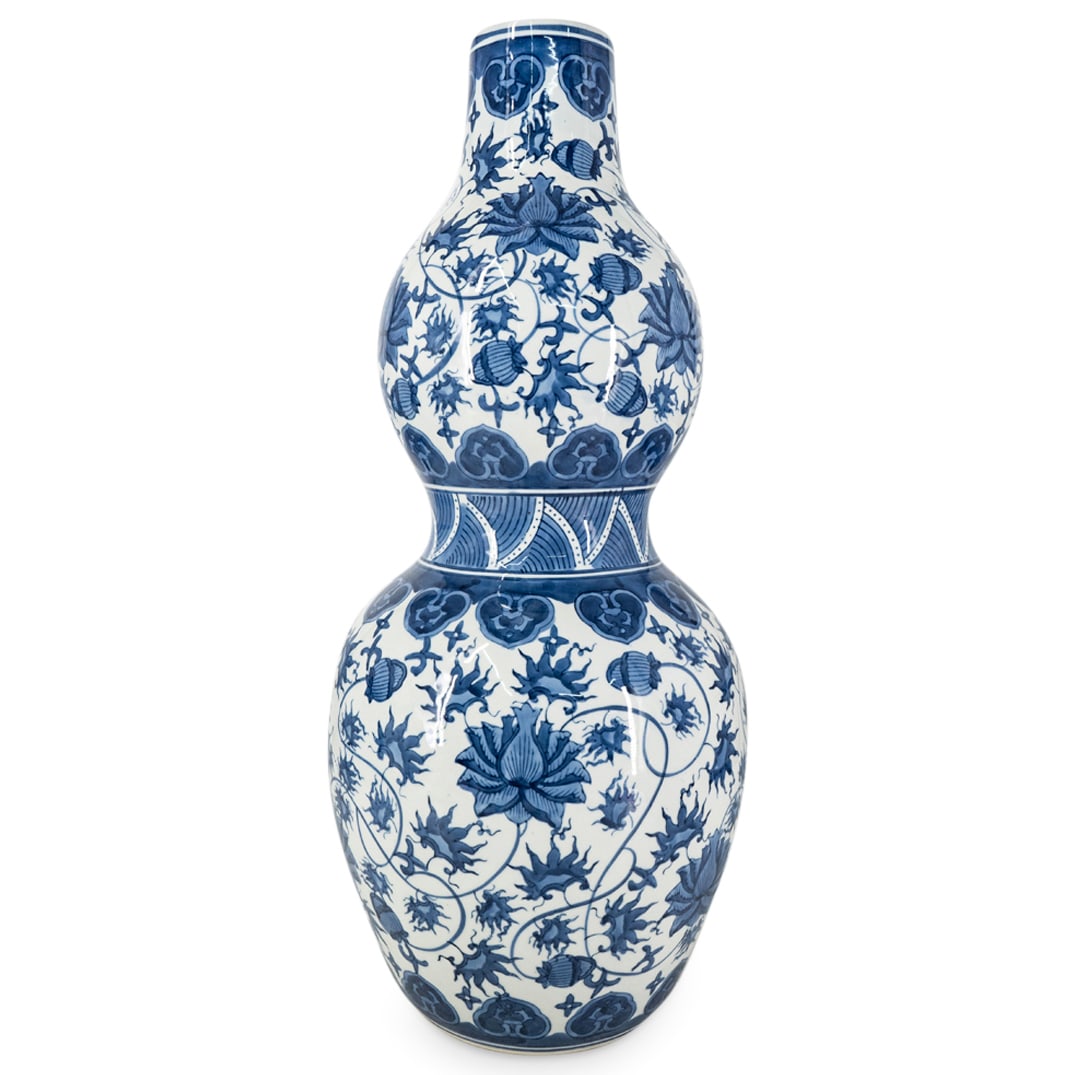 Vintage Chinese Blue And White Double Gourd Vase: DESCRIPTION: Vintage porcelain huluping ("double gourd vase") featuring blue and white lotus and lingzhi ("ganoderma mushroom") patterns. CIRCA: 20th Century ORIGIN: China DIMENSIONS: H: 23" D: 9.5" C