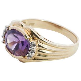 14k Gold, Alexandrite and Diamond Ring: DESCRIPTION: A 14k yellow gold ring centered by an oval cut purple Alexandrite, accented on either side with Diamonds. The ring stamped along the inner band "14k". Total Weight: 5.2 Grams CIRCA: 20th