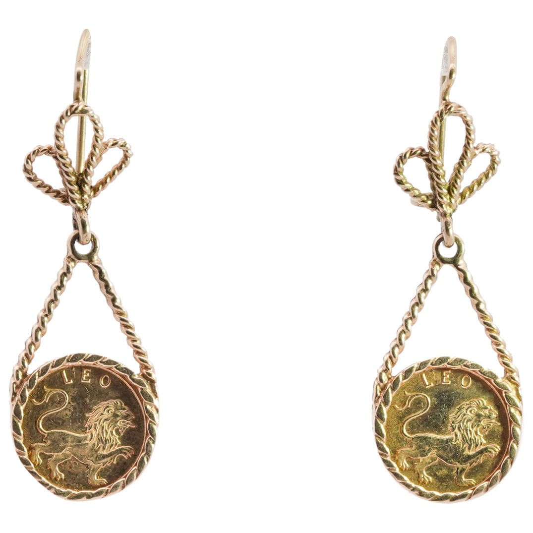 Vintage 14k Gold Astrology Leo Earrings: DESCRIPTION: A pair of 14k yellow gold earrings feature a braided wire frame sustaining Leo medallions decorated with lion motifs, designed with clover motif on the verso. Total Weight: 7.7 Grams (4.9