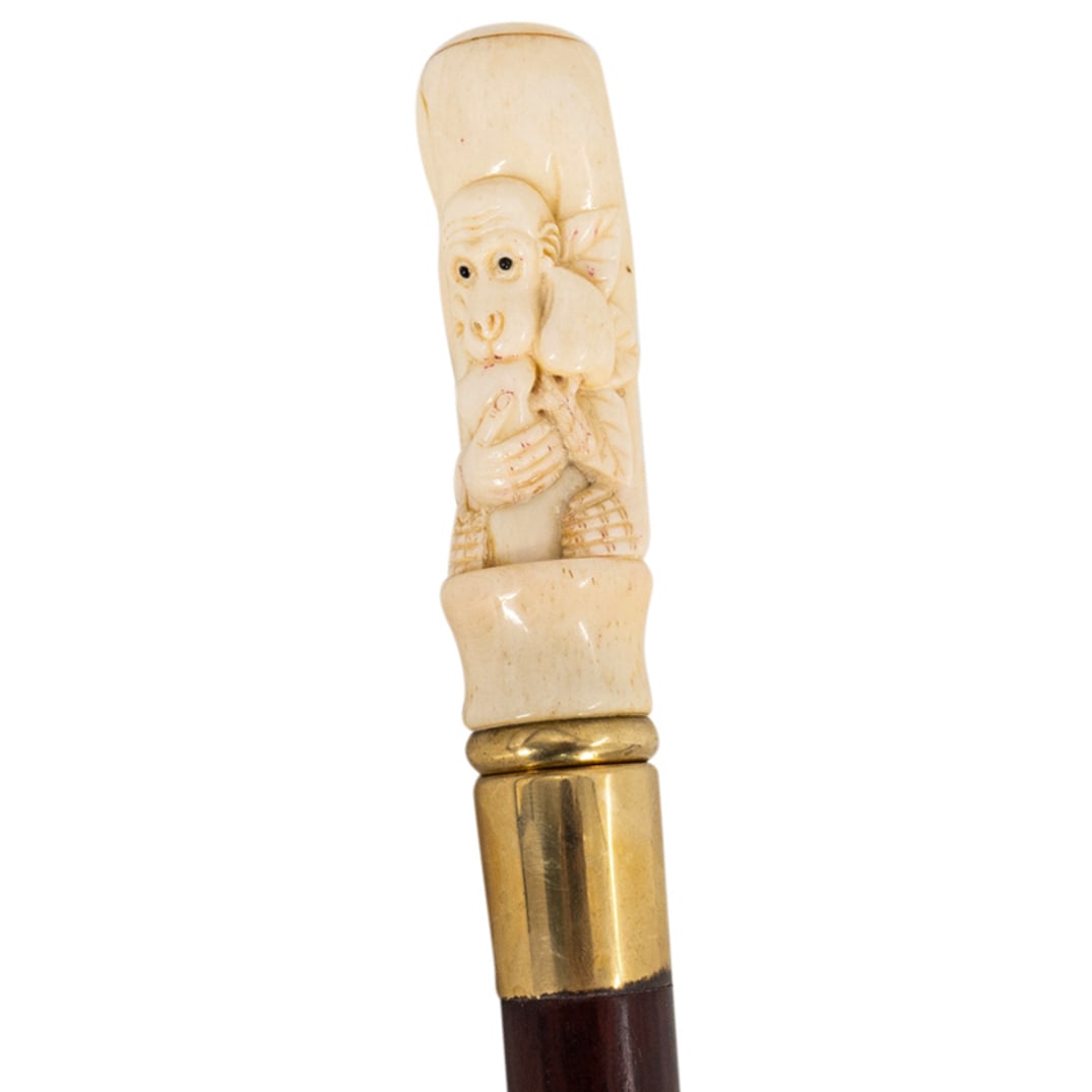 Vintage Japanese Carved Wood & Bone Monkey Walking Cane: DESCRIPTION: Vintage Japanese carved wood walking cane with carved bone monkey shaped handle. Further embellished with brass accents. CIRCA: 20th Century ORIGIN: Japan DIMENSIONS: L: 36" CONDITION: Go