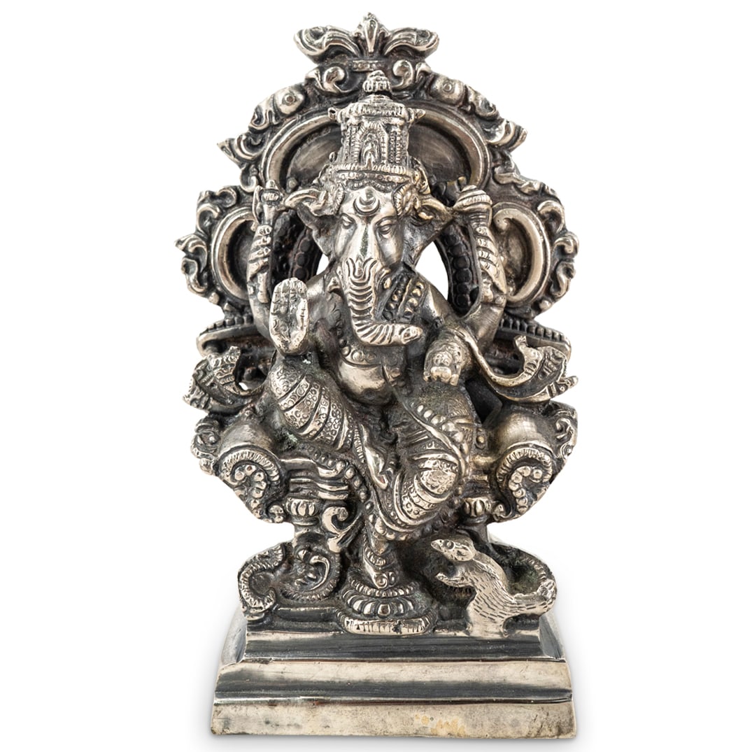 Vintage Indian Mixed Metal Ganesha: DESCRIPTION: Mixed metal Hindu sculpture depicting Ganesha seated on a throne backed by a ring of foliage and accompanied by his mount, Mushika. CIRCA: 20th Century ORIGIN: India DIMENSIONS: H: 7.5" W
