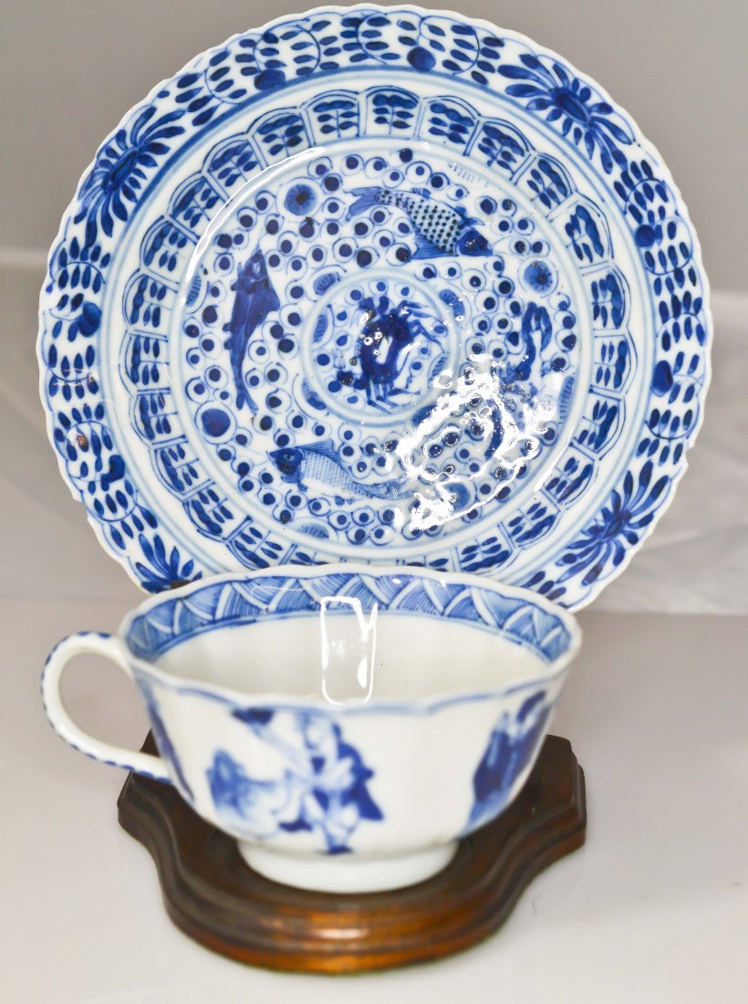 Qing dynasty porcelain tea set: DESCRIPTION: Qing dynasty blue and white porcelain tea set comes on wood stand. Hallmarked underneath CIRCA: China MADE IN: 18/19th ct DIMENSIONS: H:1.75" 5.5"in diameter