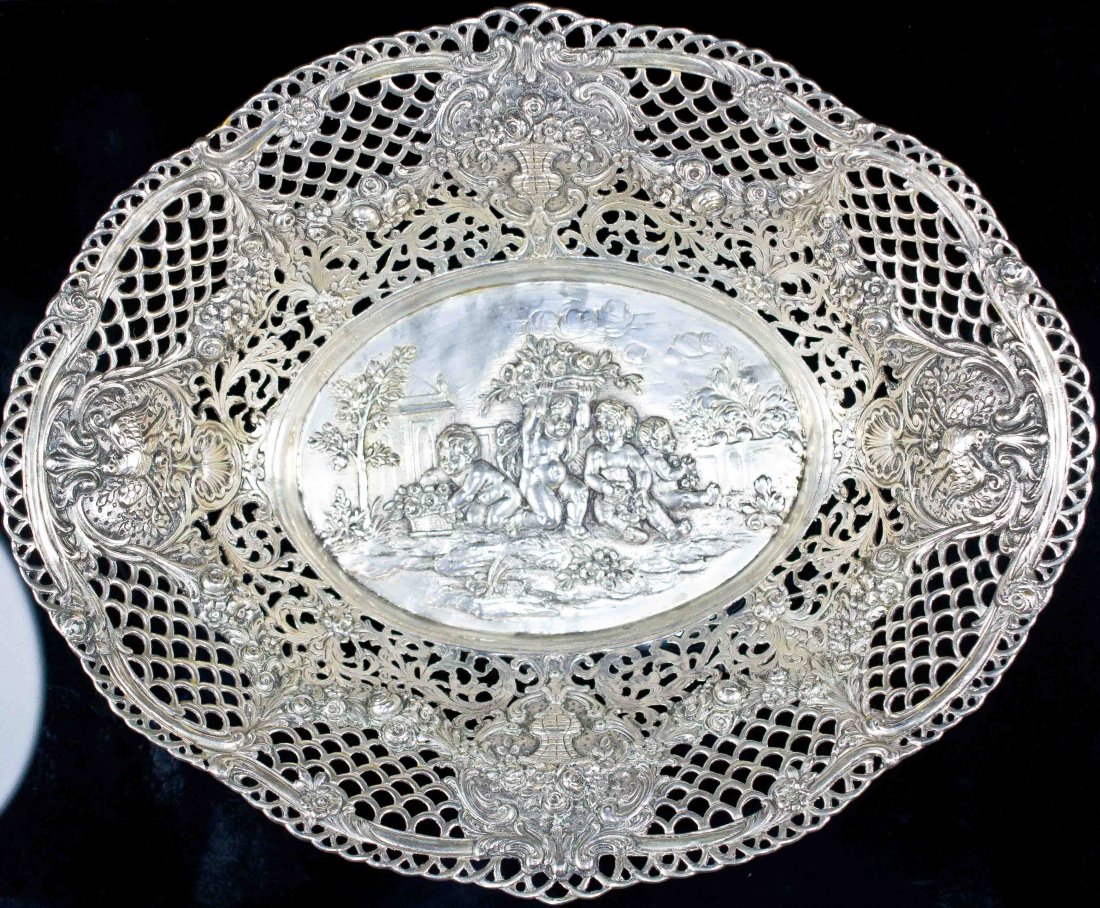 Antique baroque silver serving basket: DESCRIPTION: Antique baroque figural and floral silver serving basket. Gorgeous ornate design. No hallmarks but tested silver Weighs 10 ounces. CIRCA: 19/20th ct MADE IN: Europe DIMENSIONS: H:2.5" L:1