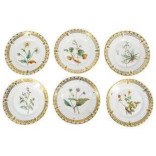 (6 Pc) Royal Copenhagen Porcelain Plates: DESCRIPTION: Six Royal Copenhagen porcelain plates, each featuring a floral motif in its well and gilt accenting and fruit, floral, or foliage motifs on its lip. Hallmarked on underside. CIRCA: 20th