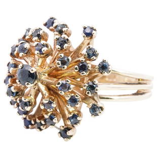 14k Gold and Sapphire Ring: DESCRIPTION: 14k yellow gold ring featuring a cluster setting inset with a series of round cut sapphires, stamped along the inner band "14k". Total weight: 11 grams (7 dwt) CIRCA: 20th Cent. 