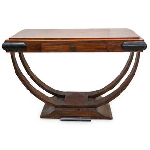 Art Deco Console Table: DESCRIPTION: Art Deco wood carved console table featuring ebonized accents, center pull-out drawer, and curved side supporting ribs. CIRCA: Early 20th Cent. ORIGIN: Continental DIMENSIONS: H: 33.5" x