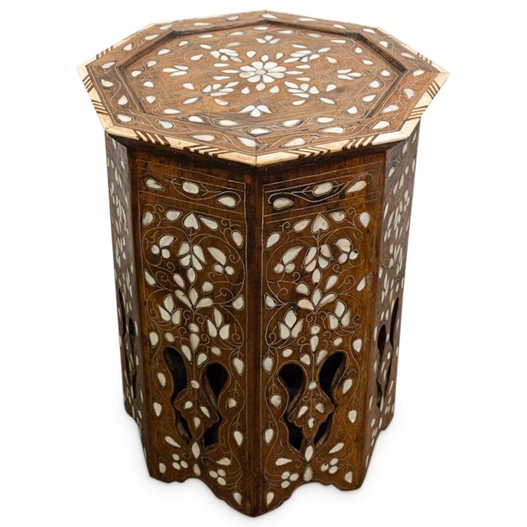Moroccan Carved Wood, Bone, Mother Of Pearl Side Table: DESCRIPTION: Octagonal side table crafted from carved wood fitted with mother-of-pearl flowers connected by silvered metal foliage. Finished with bone edges around top. CIRCA: Late 19th to early 20th 