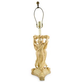 Antique Carved Alabaster Three Graces Lamp: DESCRIPTION: Antique neoclassical electric lamp depicting the three Graces holding a floral garland and dancing atop a base decorated with three lion's heads and incised foliage motifs. Tested and ful