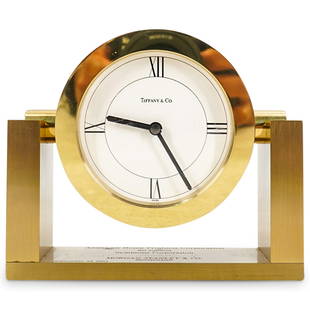 Tiffany & Co. Desk Clock: DESCRIPTION: Tiffany & Co. desk clock with gold tone and white dial. Signed at dial: "Tiffany & Co. Swiss Made" engraved inscription from: "Morgan Stanley & Co." with quartz battery movement. CIRCA: 1