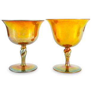 Pair Steuben Carder Era Gold Aurene Sherbets: DESCRIPTION: Pair of Frederick Carder-era Steuben iridescent gold Aurene glass sherbets, shape #2361, each featuring twisted stem with blue Aurene accents. One sherbet marked on underside with "Aurene