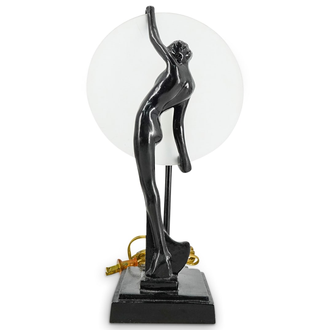 Art Deco Mixed Metal Nude Woman Table Lamp: DESCRIPTION: Table lamp featuring a shade crafted as a nude woman holding a large, frosted glass, vertical disc. Tested and fully functional. CIRCA: 20th Century ORIGIN: Continental DIMENSIONS: H: 14.