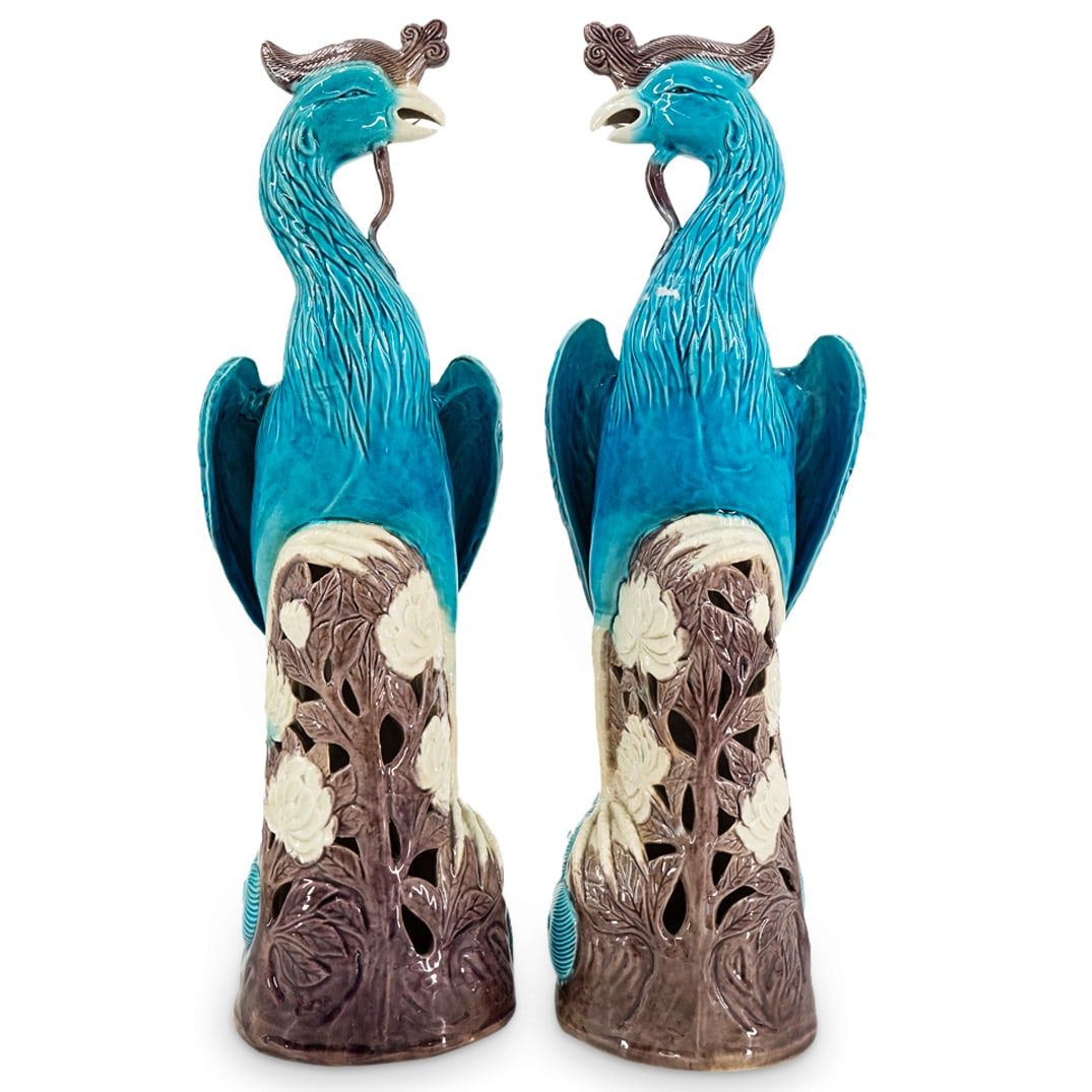 Pair Chinese Porcelain Fenghuang Sculptures: DESCRIPTION: Pair of mirrored Chinese porcelain sculptures, each depicting a fenghuang ("Chinese phoenix") perched atop an openwork tree and each featuring blue and purple-hued glazing. CIRCA: 20th Ce