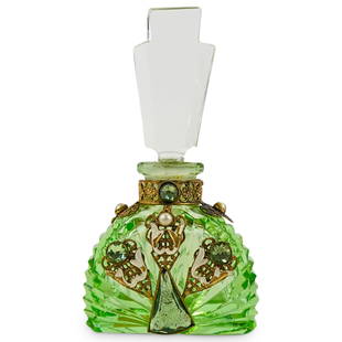 Prob. Hoffman Bejeweled Uranium Glass Perfume Bottle: DESCRIPTION: Probably Heinrich Hoffman perfume bottle composed of uranium glass body and clear glass finial, the body featuring bejeweled gilt filigree applications with enamel accents. CIRCA: 20th Ce