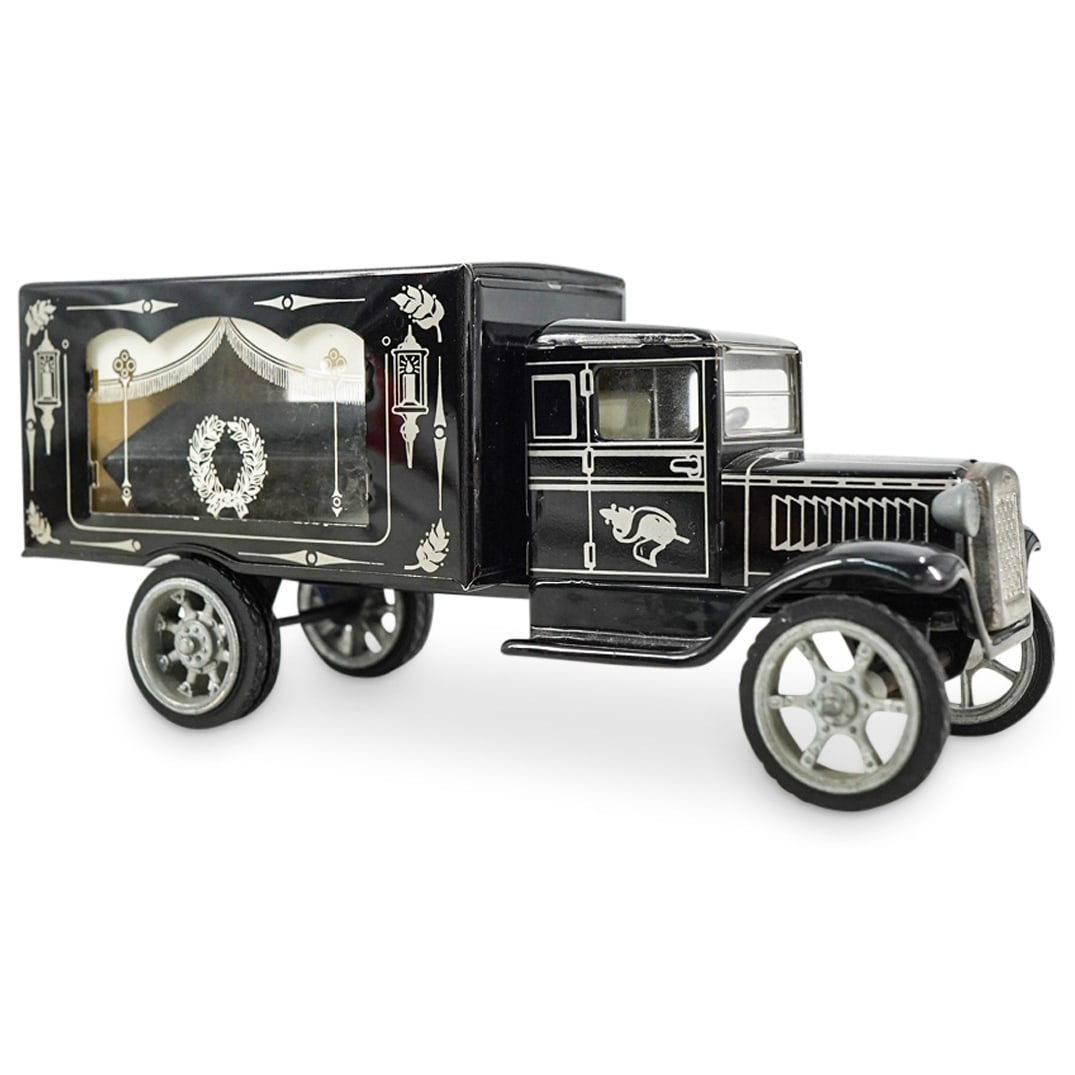 Antique Kovap Mourning Memento Mori Tin Hearse: DESCRIPTION: Antique Kovap memento mori tin hearse featuring functioning wheels; a casket in rear cabin; and white wreath, curtain, and sconce designs. Branded on underside. CIRCA: Early 20th Century 