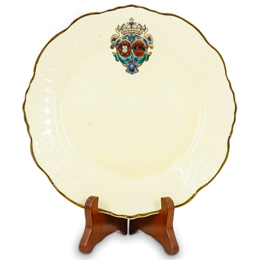 Porcelain Plate From King Of Portugal's Service: DESCRIPTION: Porcelain plate from a tableware service belonging to the king and queen of Portugal and featuring textured foliage designs on lip accented with gilt rim and finished with regal heraldry 