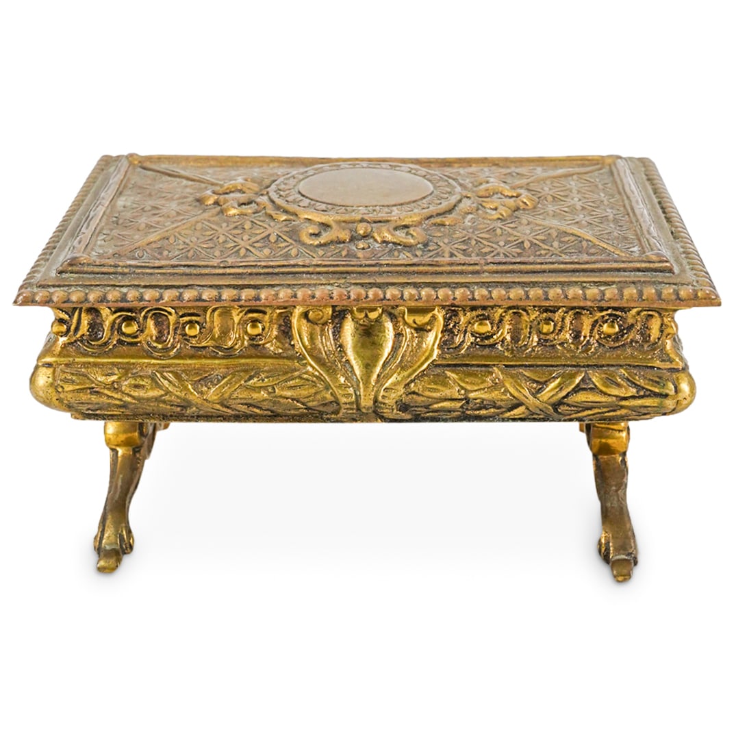 Antique Portuguese Trinket Box: DESCRIPTION: Antique Portuguese gilt mixed metal trinket box featuring foliage motifs, velvet-lined interior, four legs and hinged lid. Marked with "Portugal" at underside. CIRCA: Early 20th Century O