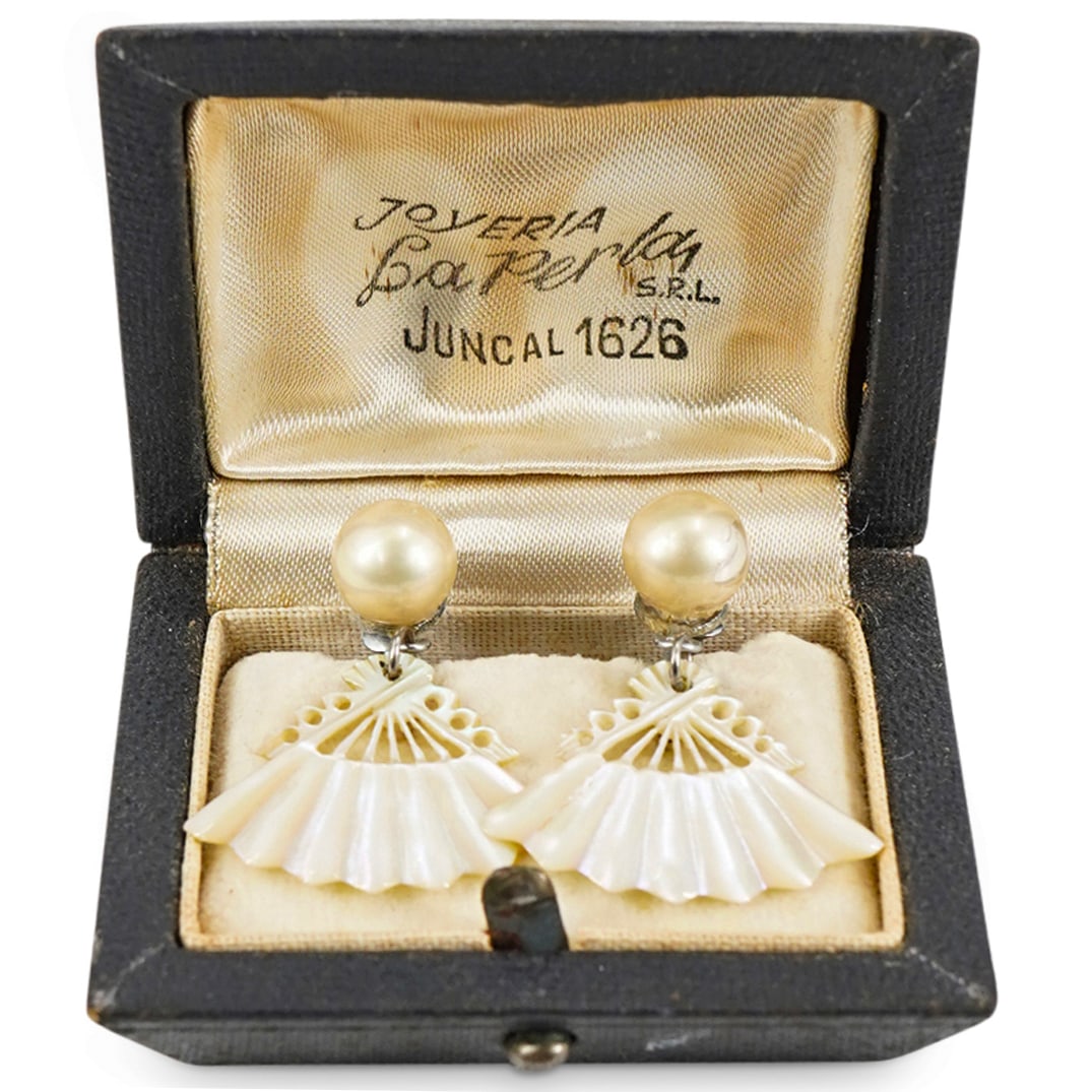 Pair Of Mother Of Pearl Fan Earrings: DESCRIPTION: Two matching earrings, each crafted from a round bead from which hangs a carved, pierced fan-form pendants. Includes box. CIRCA: 20th Century ORIGIN: USA DIMENSIONS: Earrings - W: 1" L: 1