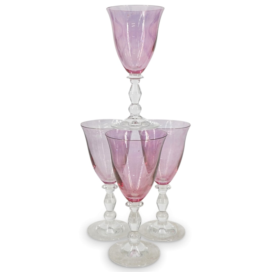 (4 Pc) Vintage Italian Interglass Wine Glasses: DESCRIPTION: Four Interglass Murano glass wine glasses, each featuring a rosy pink bowl with a flared lip and a clear stem of three shapes atop a flared foot. One piece bears an Interglass sticker mar